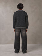 Model wearing the SM Jacquard Knitted Sweatshirt in Midnight Black, rear view.