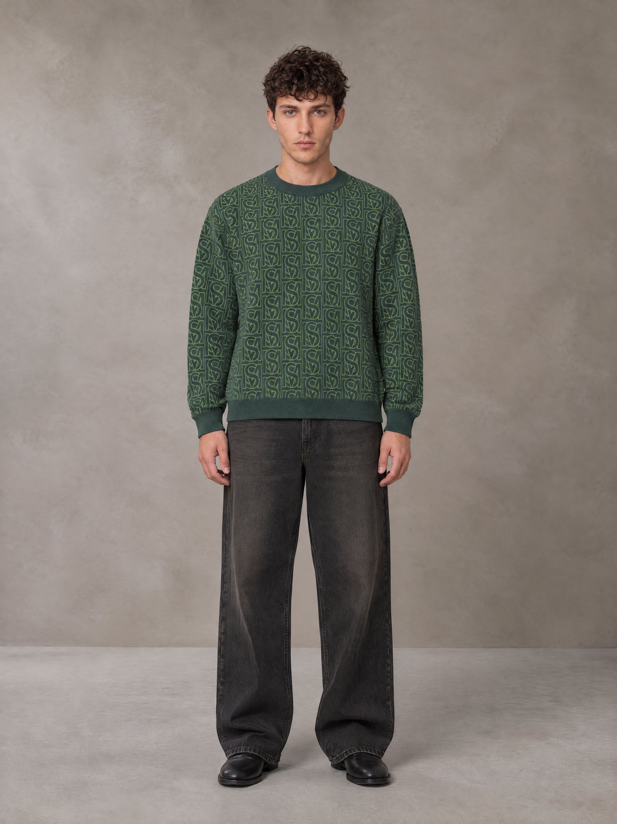 Model wearing the SM Jacquard Knitted Sweatshirt in Dark Green, front view.