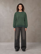 Model wearing the SM Jacquard Knitted Sweatshirt in Dark Green, front view.