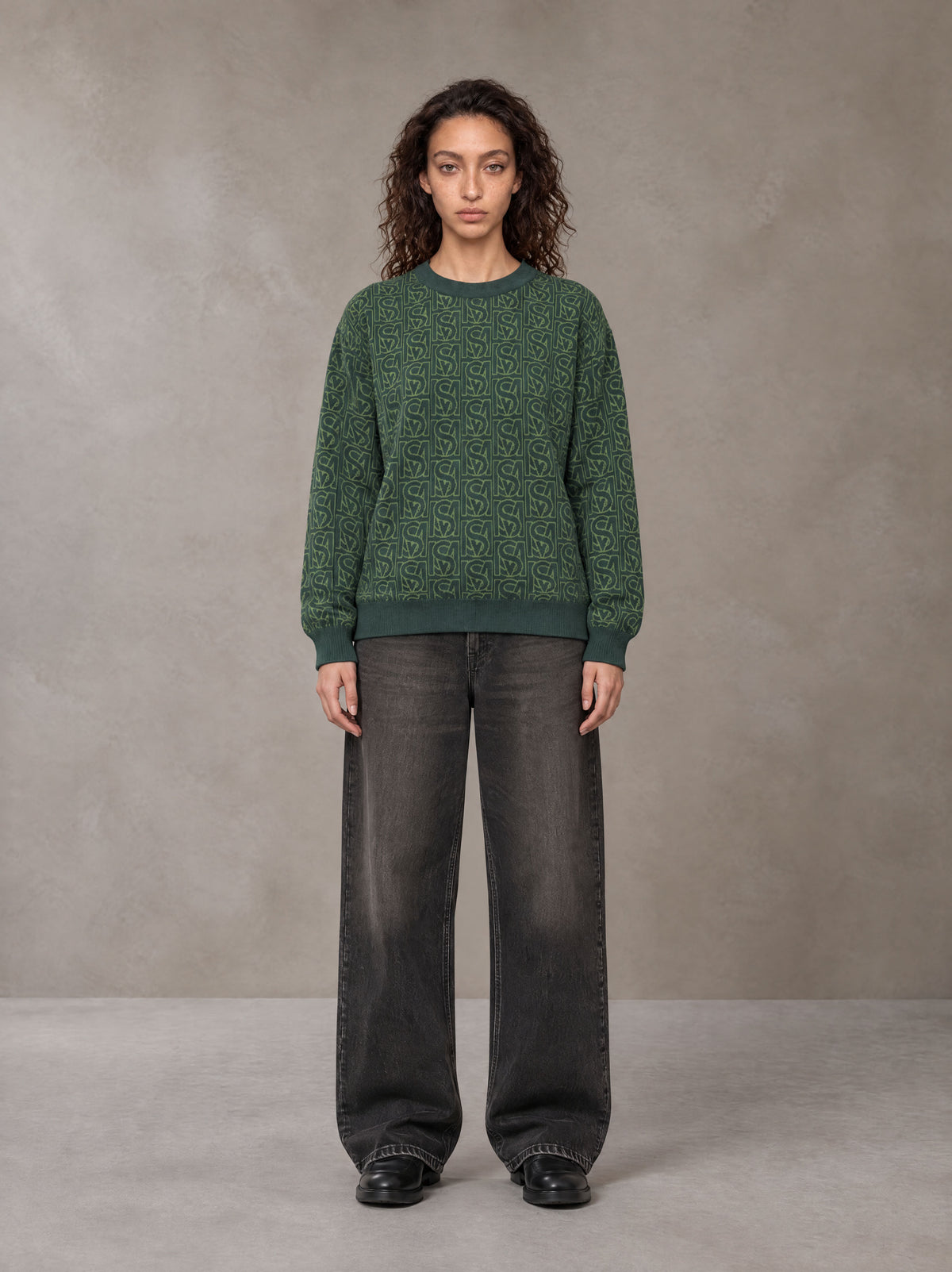 Model wearing the SM Jacquard Knitted Sweatshirt in Dark Green, front view.