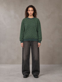 Model wearing the SM Jacquard Knitted Sweatshirt in Dark Green, front view.