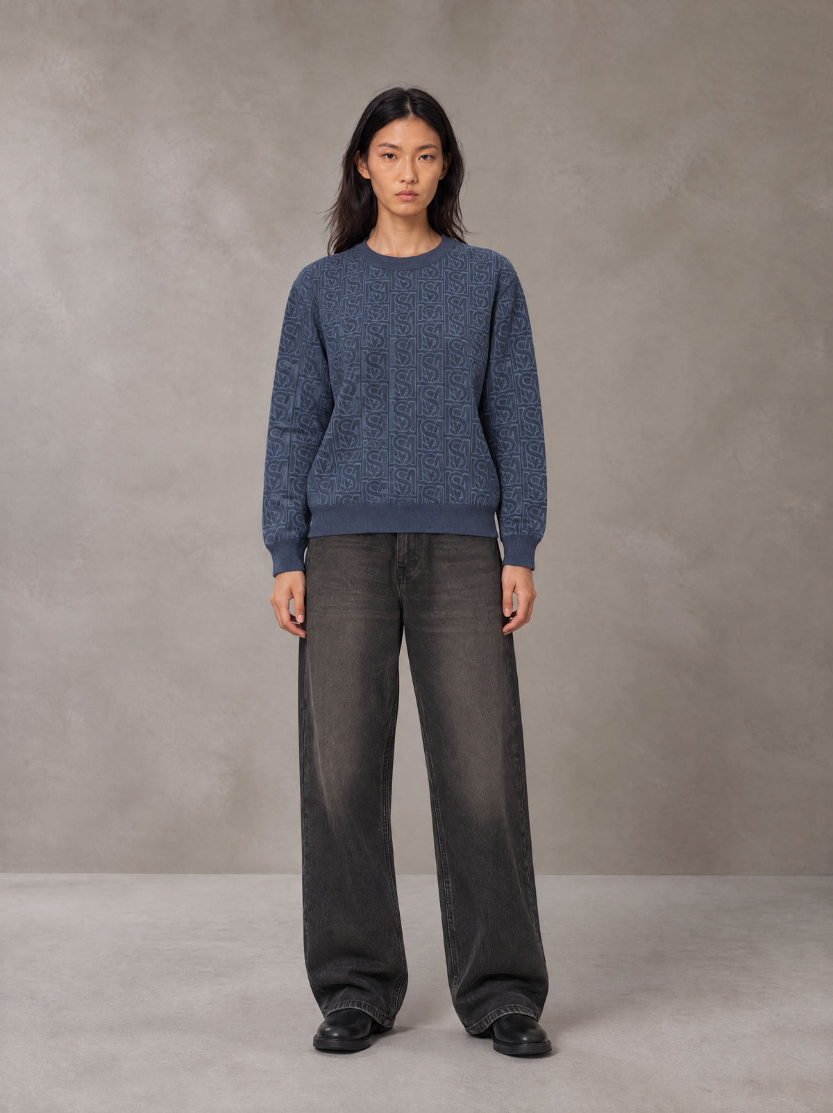 Model wearing the SM Jacquard Knitted Sweatshirt in Chambray, front view.