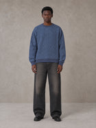 Model wearing the SM Jacquard Knitted Sweatshirt in Chambray, front view.