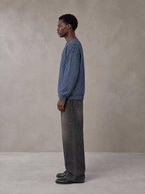 Model wearing the SM Jacquard Knitted Sweatshirt in Chambray, side profile.