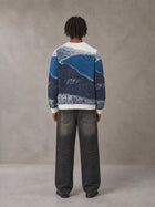 Model wearing the SM Seascape Jacquard Knitted Sweatshirt in Chambray, rear view.