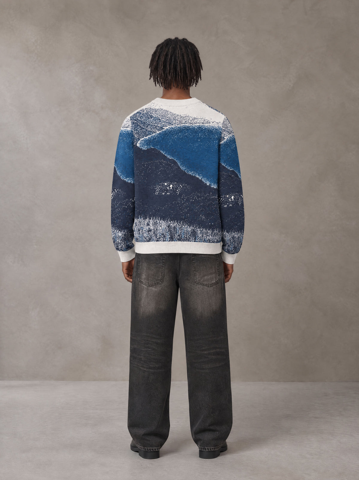 Model wearing the SM Seascape Jacquard Knitted Sweatshirt in Chambray, rear view.