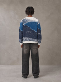 Model wearing the SM Seascape Jacquard Knitted Sweatshirt in Chambray, rear view.