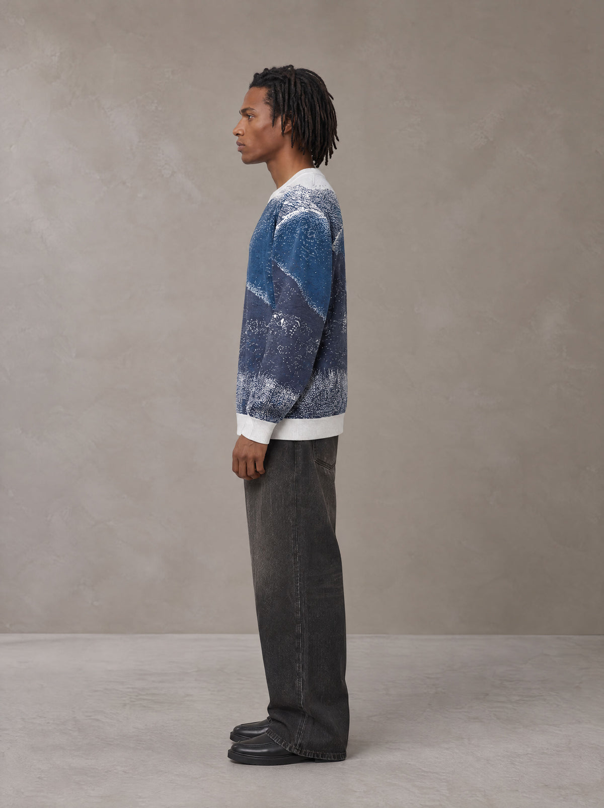 Model wearing the SM Seascape Jacquard Knitted Sweatshirt in Chambray, side profile.