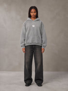 Model wearing the SM Monkey Wash Hoodie in Pure Grey, front view.