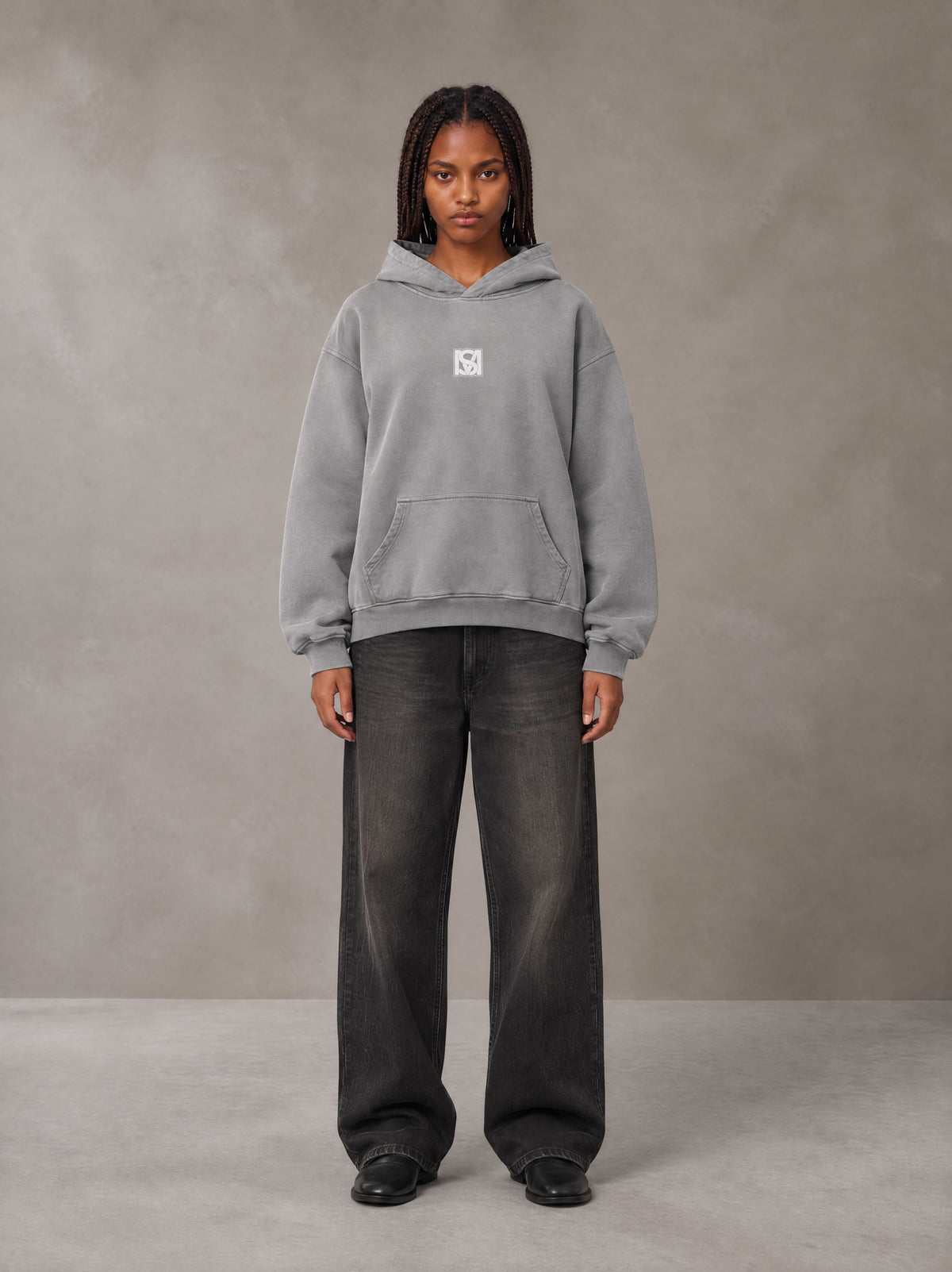 Model wearing the SM Monkey Wash Hoodie in Pure Grey, front view.