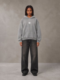 Model wearing the SM Monkey Wash Hoodie in Pure Grey, front view.