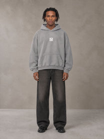Model wearing the SM Monkey Wash Hoodie in Pure Grey, front view.