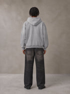 Model wearing the SM Monkey Wash Hoodie in Pure Grey, rear view.