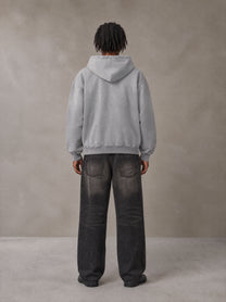 Model wearing the SM Monkey Wash Hoodie in Pure Grey, rear view.