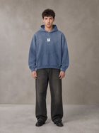 Model wearing the SM Monkey Wash Hoodie in Chambray, front view.