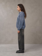 Model wearing the SM Monkey Wash Hoodie in Chambray, side profile.