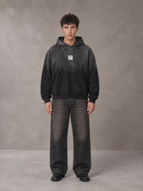 Model wearing the SM Monkey Wash Hoodie in Midnight Black, front view.