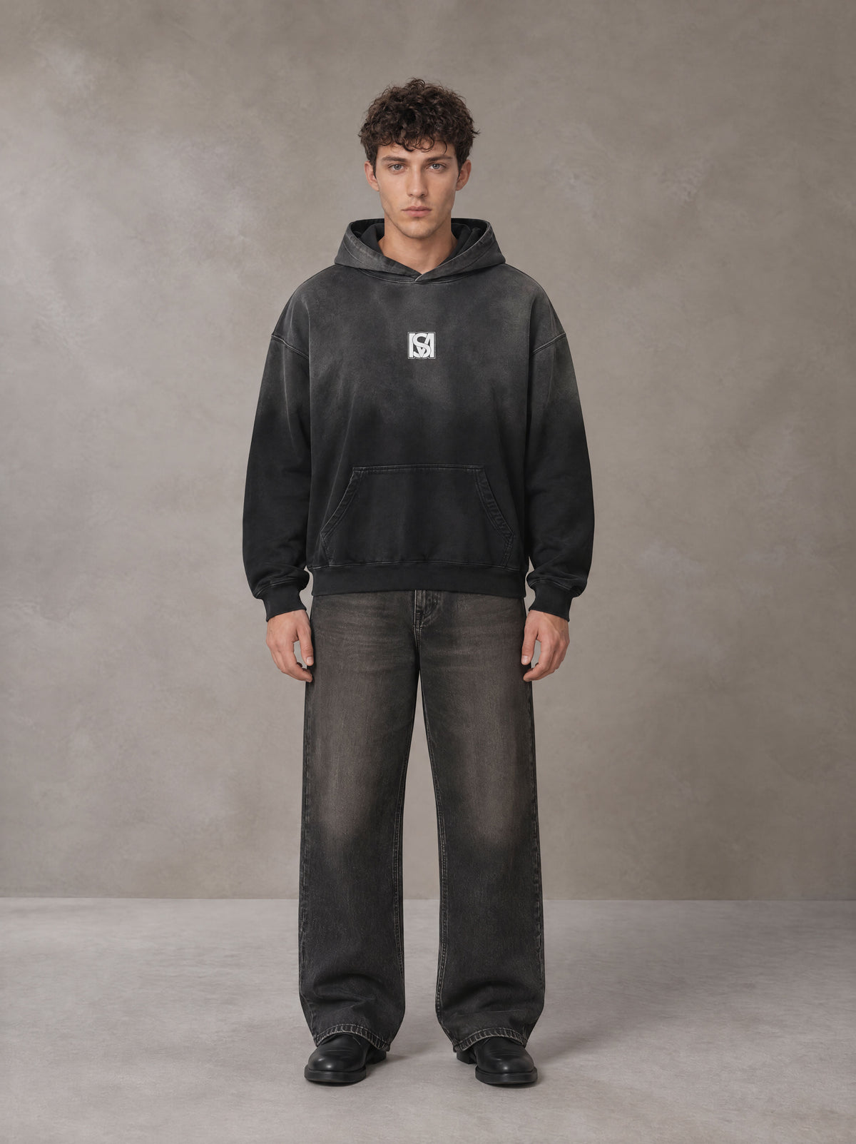 Model wearing the SM Monkey Wash Hoodie in Midnight Black, front view.