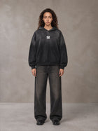 Model wearing the SM Monkey Wash Hoodie in Midnight Black, front view.