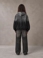 Model wearing the SM Monkey Wash Hoodie in Midnight Black, rear view.