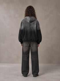 Model wearing the SM Monkey Wash Hoodie in Midnight Black, rear view.
