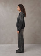 Model wearing the SM Monkey Wash Hoodie in Midnight Black, side profile.
