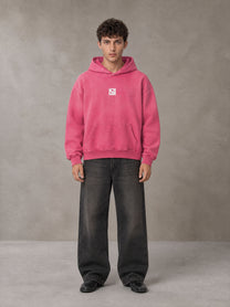 Model wearing the SM Monkey Wash Hoodie in Vivid Pink, front view.