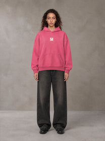 Model wearing the SM Monkey Wash Hoodie in Vivid Pink, front view.