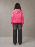 Model wearing the SM Monkey Wash Hoodie in Vivid Pink, rear view.