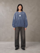 Model wearing the SM Monkey Wash Sweatshirt in Chambray, front view.