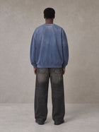 Model wearing the SM Monkey Wash Sweatshirt in Chambray, rear view.