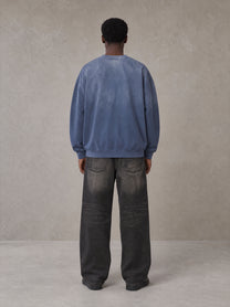 Model wearing the SM Monkey Wash Sweatshirt in Chambray, rear view.