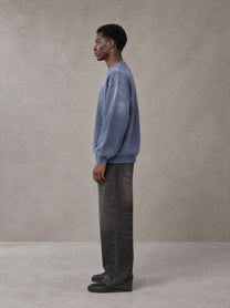 Model wearing the SM Monkey Wash Sweatshirt in Chambray, side profile.