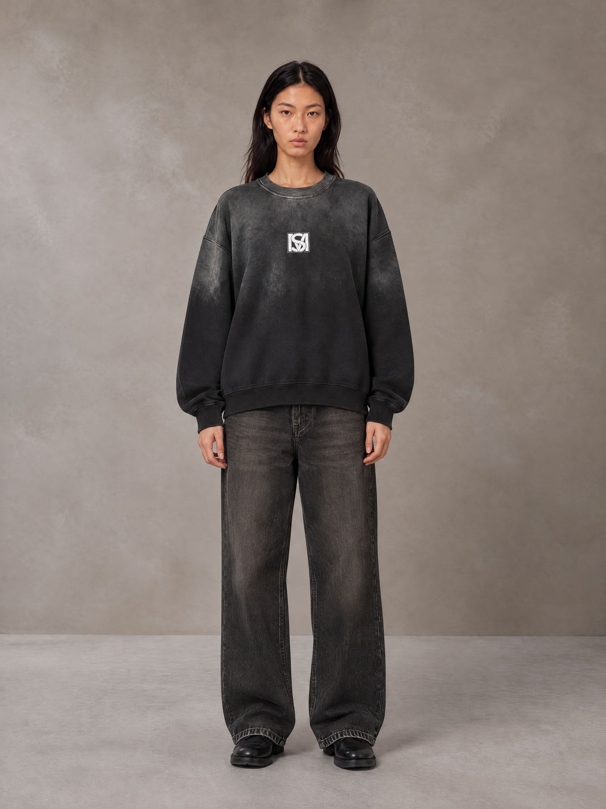 Model wearing the SM Monkey Wash Sweatshirt in Midnight Black, front view.