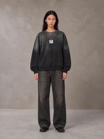 Model wearing the SM Monkey Wash Sweatshirt in Midnight Black, front view.
