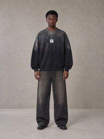 Model wearing the SM Monkey Wash Sweatshirt in Midnight Black, front view.