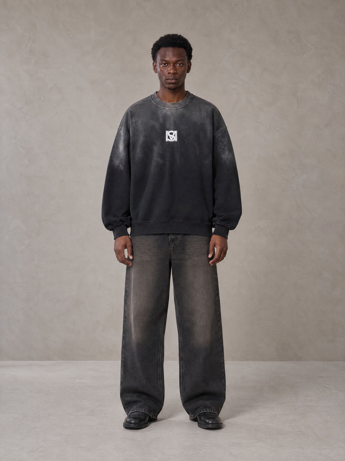 Model wearing the SM Monkey Wash Sweatshirt in Midnight Black, front view.