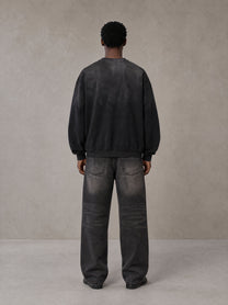Model wearing the SM Monkey Wash Sweatshirt in Midnight Black, rear view.