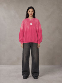 Model wearing the SM Monkey Wash Sweatshirt in Vivid Pink, front view.