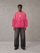 Model wearing the SM Monkey Wash Sweatshirt in Vivid Pink, front view.