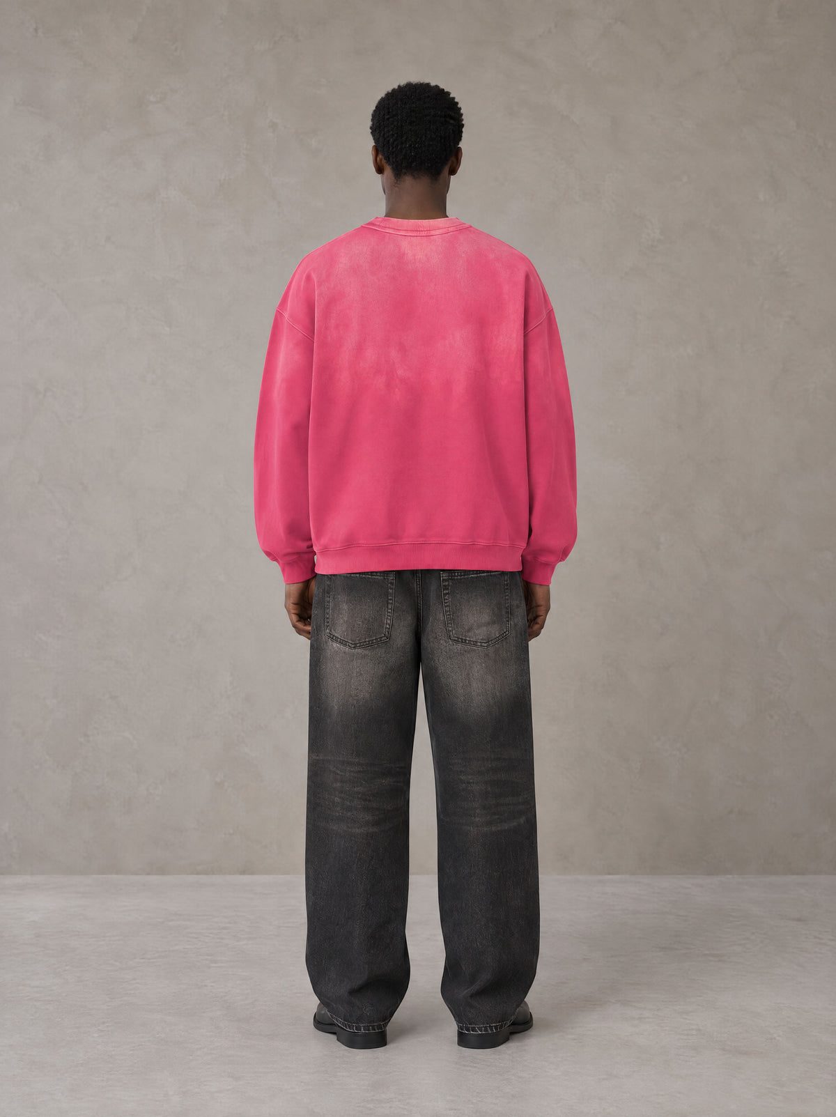 Model wearing the SM Monkey Wash Sweatshirt in Vivid Pink, rear view.