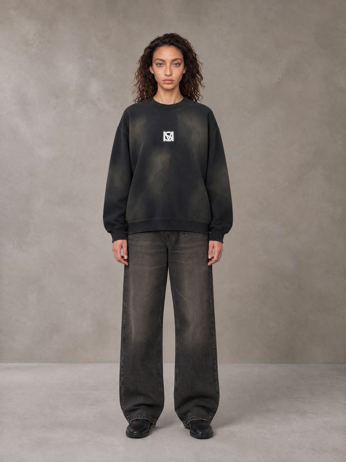 Model wearing the SM Monkey Washed Fleece Sweatshirt in Midnight Black, front view.