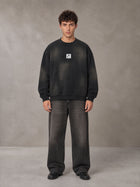 Model wearing the SM Monkey Washed Fleece Sweatshirt in Midnight Black, front view.