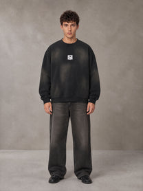 Model wearing the SM Monkey Washed Fleece Sweatshirt in Midnight Black, front view.