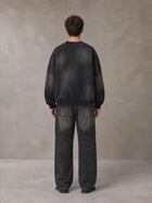 Model wearing the SM Monkey Washed Fleece Sweatshirt in Midnight Black, rear view.