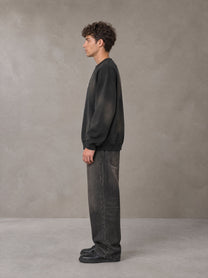 Model wearing the SM Monkey Washed Fleece Sweatshirt in Midnight Black, side profile.
