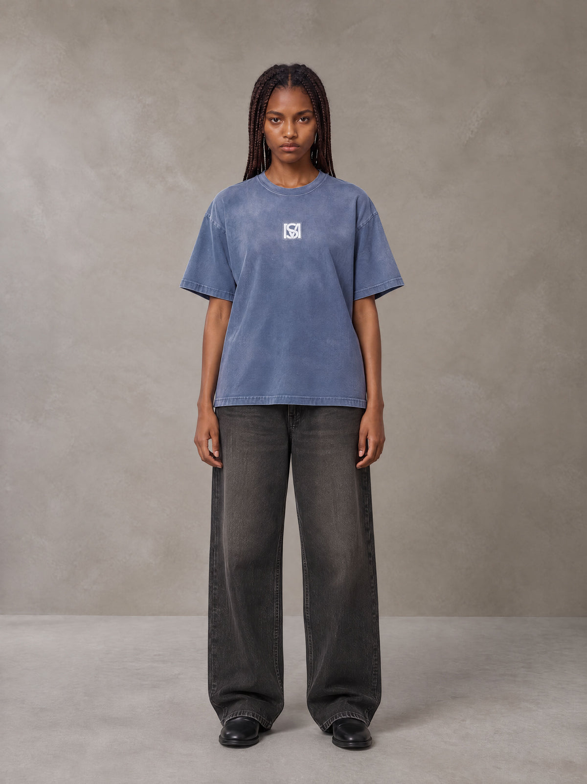 Model wearing the SM Monkey Washed T-shirt in Chambray, front view.