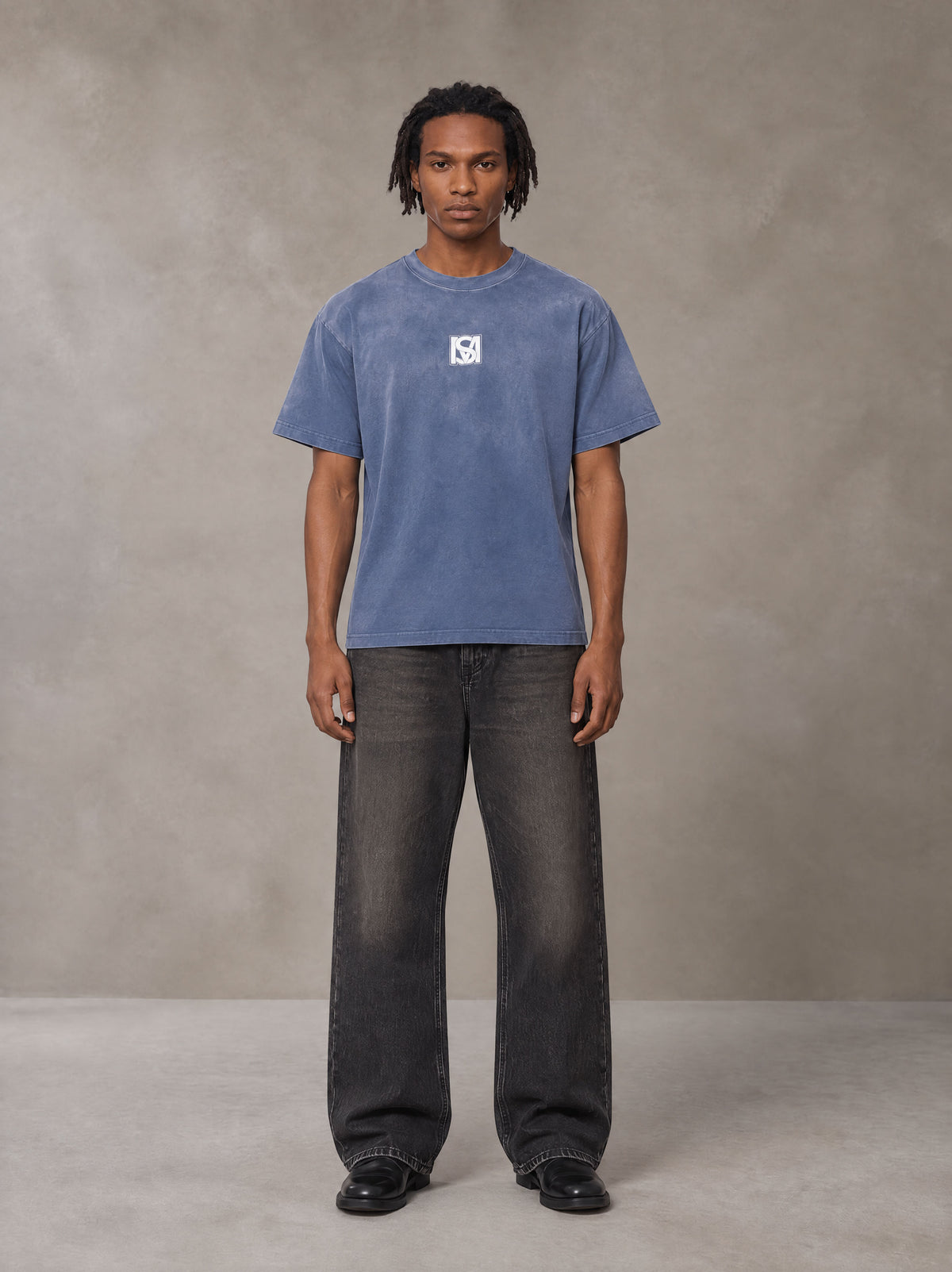 Model wearing the SM Monkey Washed T-shirt in Chambray, front view.