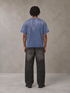 Model wearing the SM Monkey Washed T-shirt in Chambray, rear view.