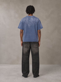 Model wearing the SM Monkey Washed T-shirt in Chambray, rear view.
